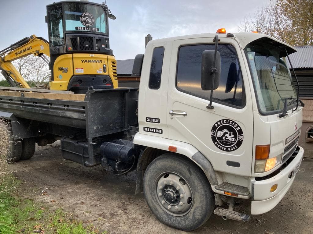 Yanmar mini excavator loaded on Precision Digger Worx branded truck