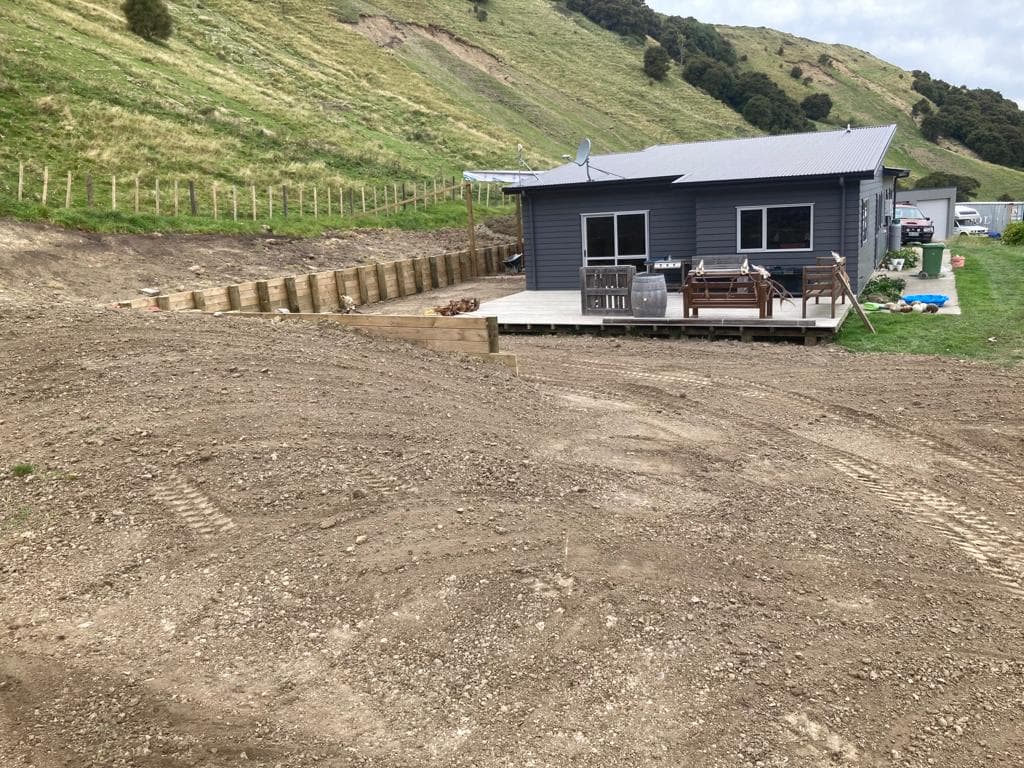 Rural residential excavation and timber retaining wall