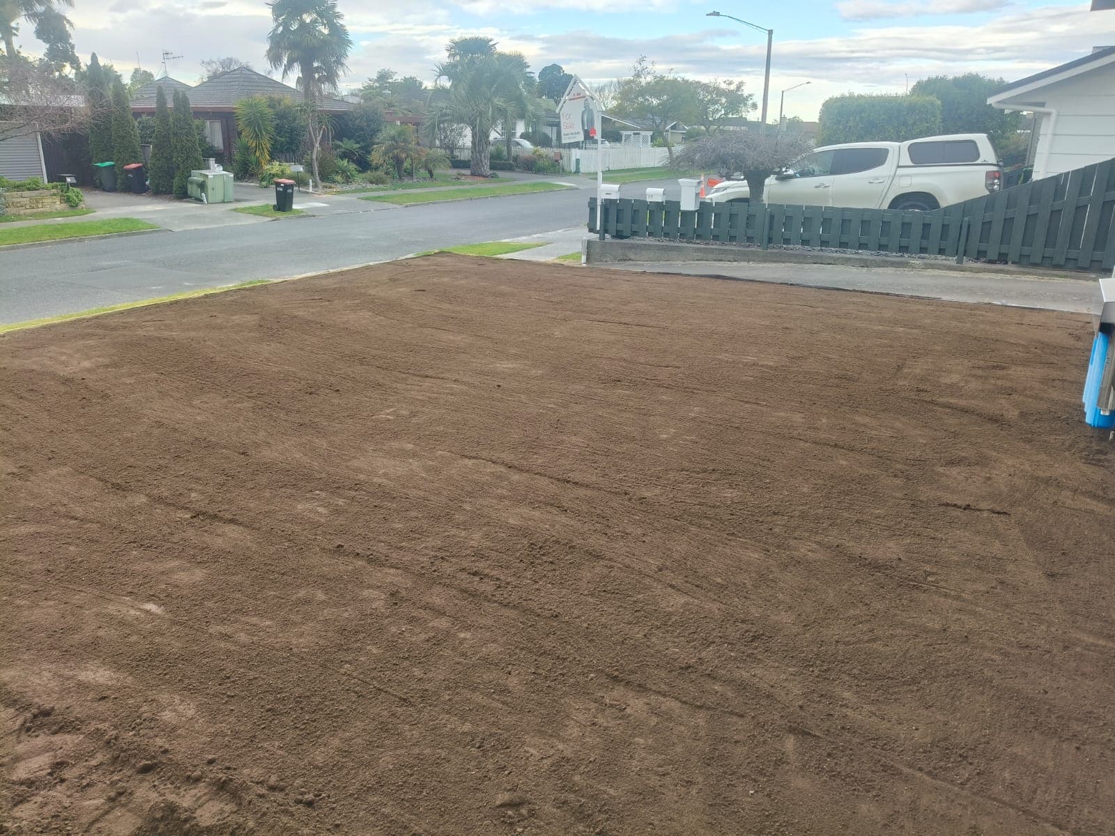 Flat, precision-levelled topsoil section near the street ready for turf