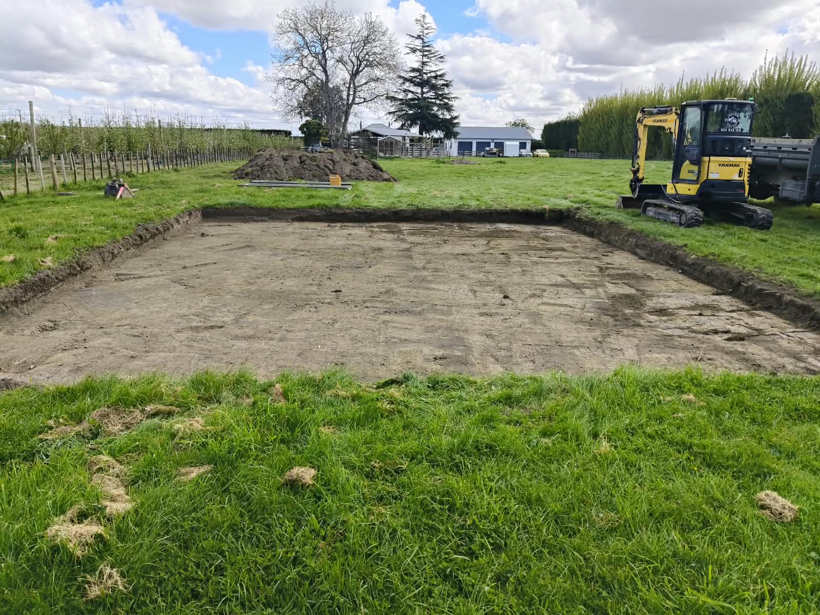 Level foundation excavation prepared across a grassy Hawke's Bay site