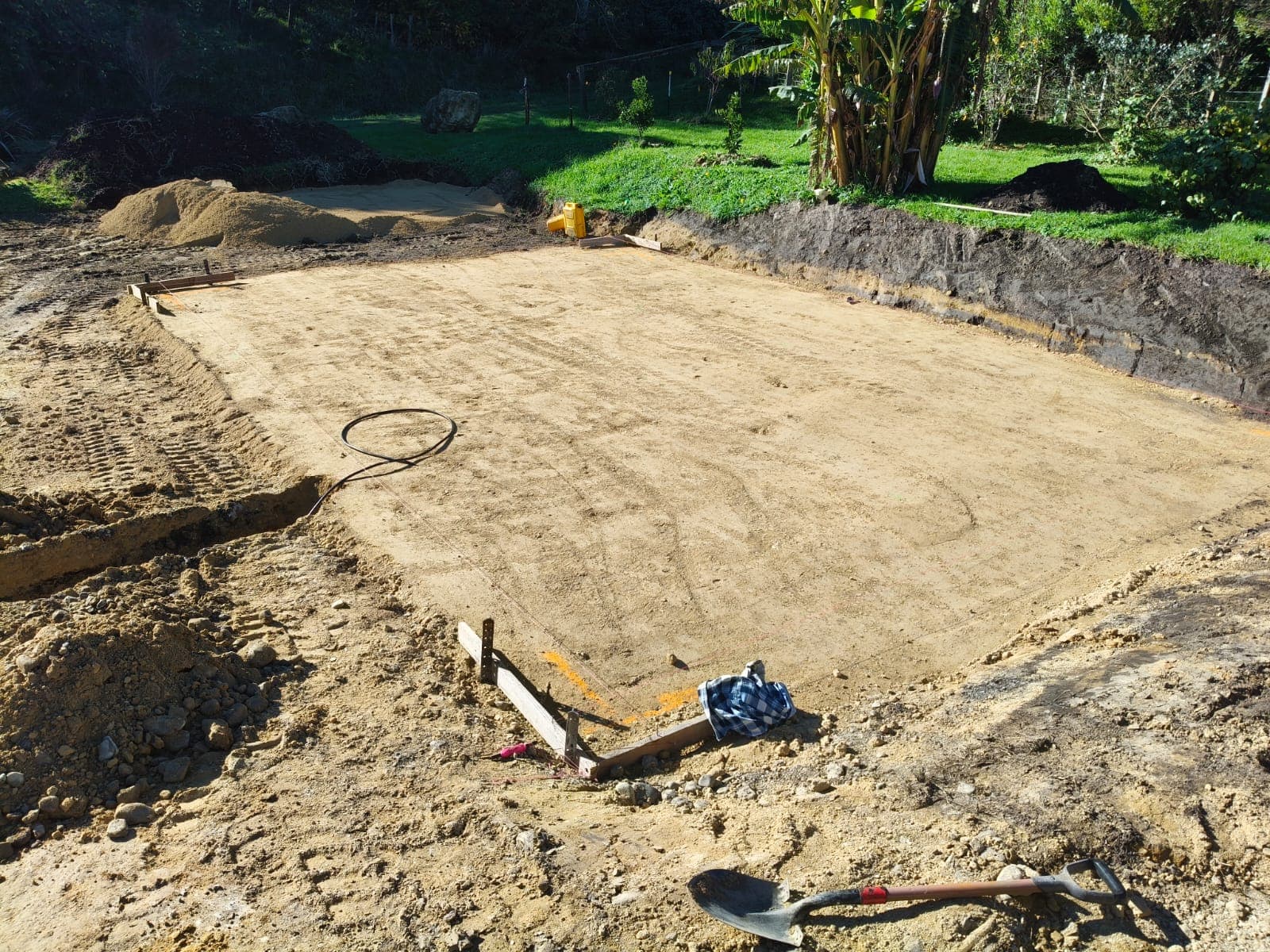 Yanmar excavator with Precision Digger Worx branding at levelled foundation site