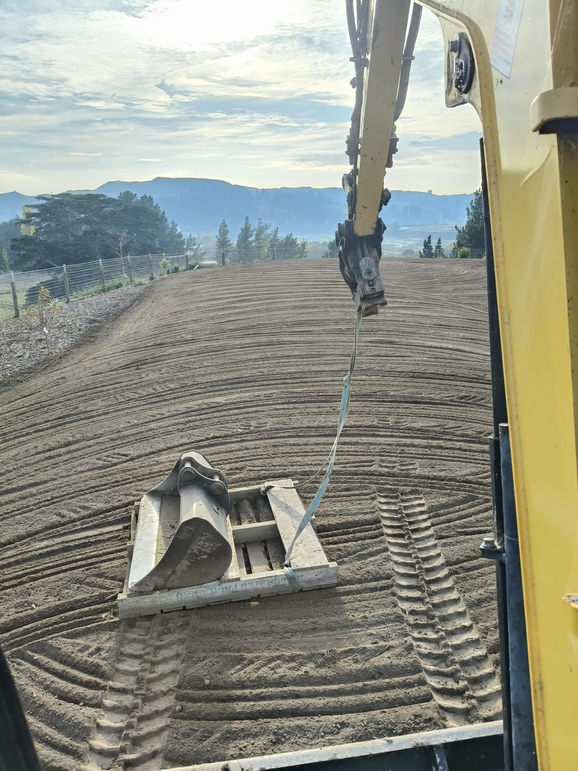 Operator view from digger cabin during bulk earthworks and topsoil work