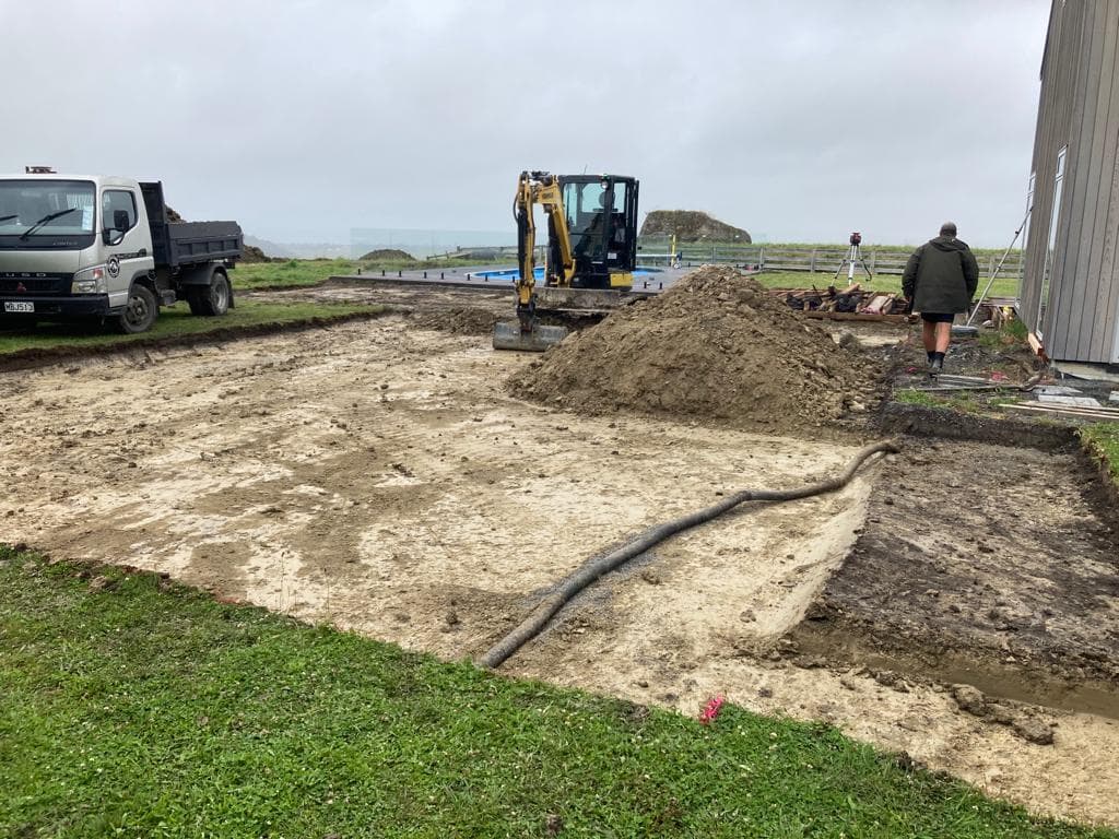 Excavator working on coastal foundation site